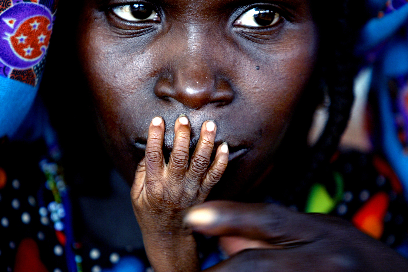 The fingers of emaciated one-year-old Alassa Galisou are pressed against the lips of his mother Fatou Ousseini at an emergency feeding clinic in Tahoua, Niger, August 1, 2005. Hardly any of the pledges announced at the G8 summit have yet translated i