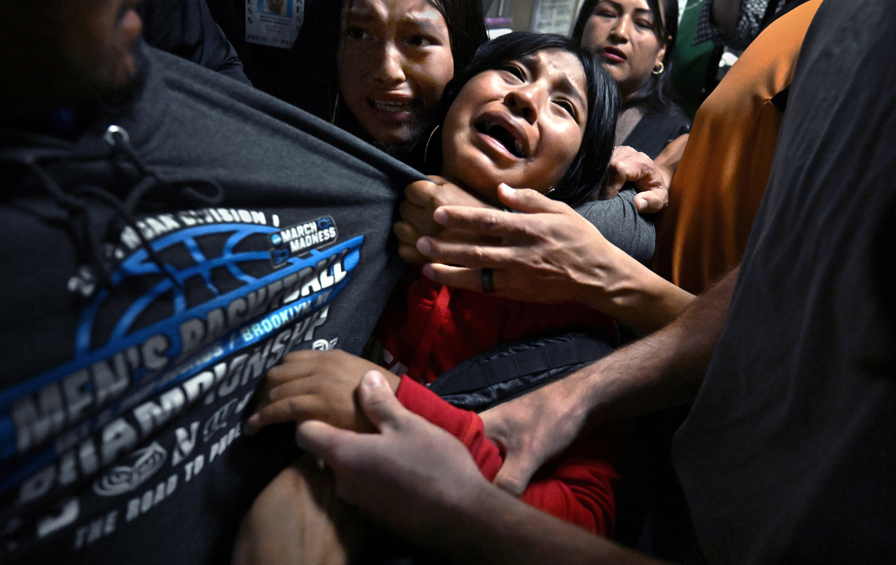 Title: ICE Arrests at New York CourtCredit: © Carol Guzy, ZUMA Press, iWitness, for Miami HeraldCaption: ​​Distraught girls cling to their father, Luis, as ICE detains him following an immigration hearing. Luis served as the sole breadwinner for 