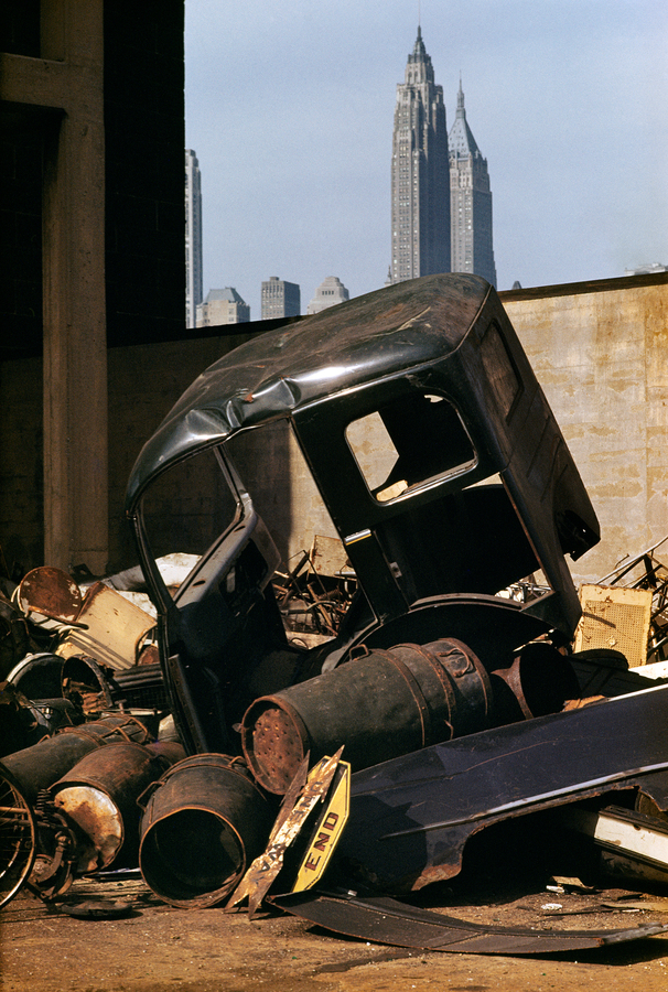 The cab of a lorry in a Brooklyn junkyard, New York City, 1952. Manhattan landmarks, the American International Building (centre, left) and 40 Wall Street (later renamed the Trump Building) can be seen in the background. Colour Photography Book(Photo