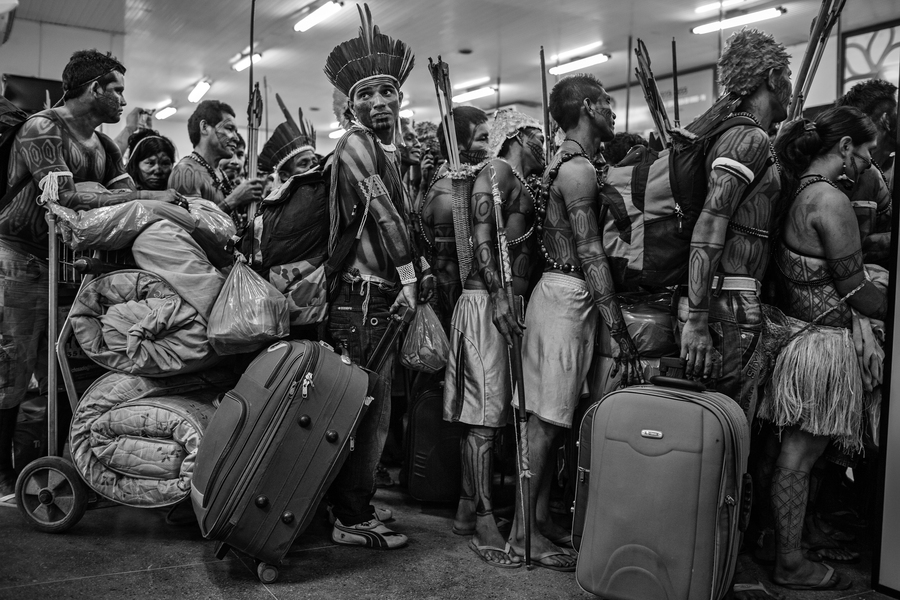 Mundurukus Indians line up to board a plane at Altamira Airport after protesting against the construction of the Belo Monte Dam on the Xingu River. The Mundurukus inhabit the banks of the Tapaj√≥s River, where the government has plans to build new hy