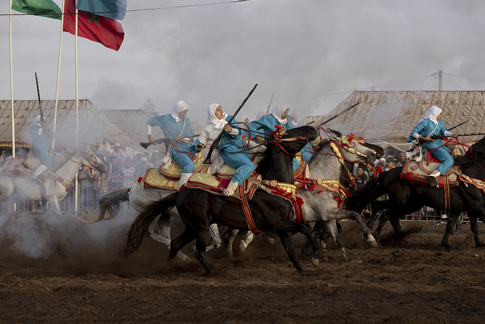 Title: Farīsāt: Gunpowder’s DaughtersCredit: © Chantal Pinzi, Panos PicturesCaption: Noura attempts to control her horse after firing, the most dangerous part of the performance. Riders risk injury from gunpowder or falling and being trampled. Si