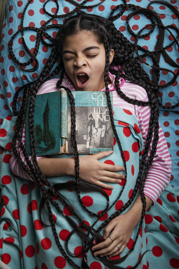 Antonella gets sleepy while studying, she often studies in bed. She feels lack of motivation. “Nothing beats being in the classroom”, she says. In this picture, I captured the moment she yawns while studying language. Sometimes she studies